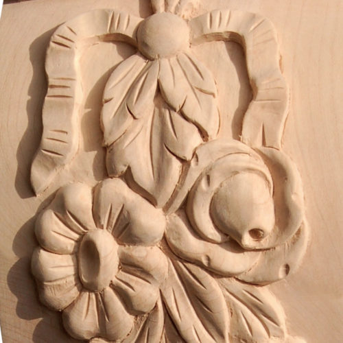 Sanford wood brackets are carved in a deep relief with flower drop on the front and flower motif on the sides