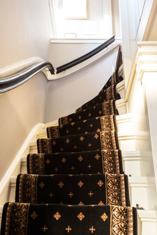 beautiful carpeted staircase with dramatic black and white railing; staircase design ideas; staircase inspiration