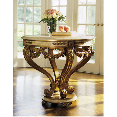 Louis XVI style round carved wood center table with antiqued gold-leaf finish. Louis XVI center table has antiqued ivory trim and Estremoz marble top with curved, beveled edge. This center table is hand made in Italy