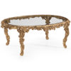 Oval carved wood coffee table with leaf motif. Carved coffee table has antiqued gold leaf finish and glass top. This carved wood table is hand-made in Italy