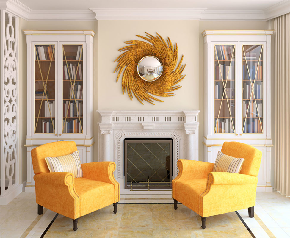 mirrors placement; living room decor with golden convex mirror over the fireplace mantel flanked by stately cabinets, and two yellow armchairs; living room design ideas