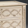 Hand-carved Tuscan style chest with raised laurel garlands finished in antique silver-leaf. Tuscan chest has a hand-painted antique white background. Tuscan chests' design features hand-carved raised laurel wreaths on the sides and fluted legs. Hand-crafted chest has two drawers with carved leaf handles and antiqued brass locks and keys. This chest is hand-crafted in Italy
