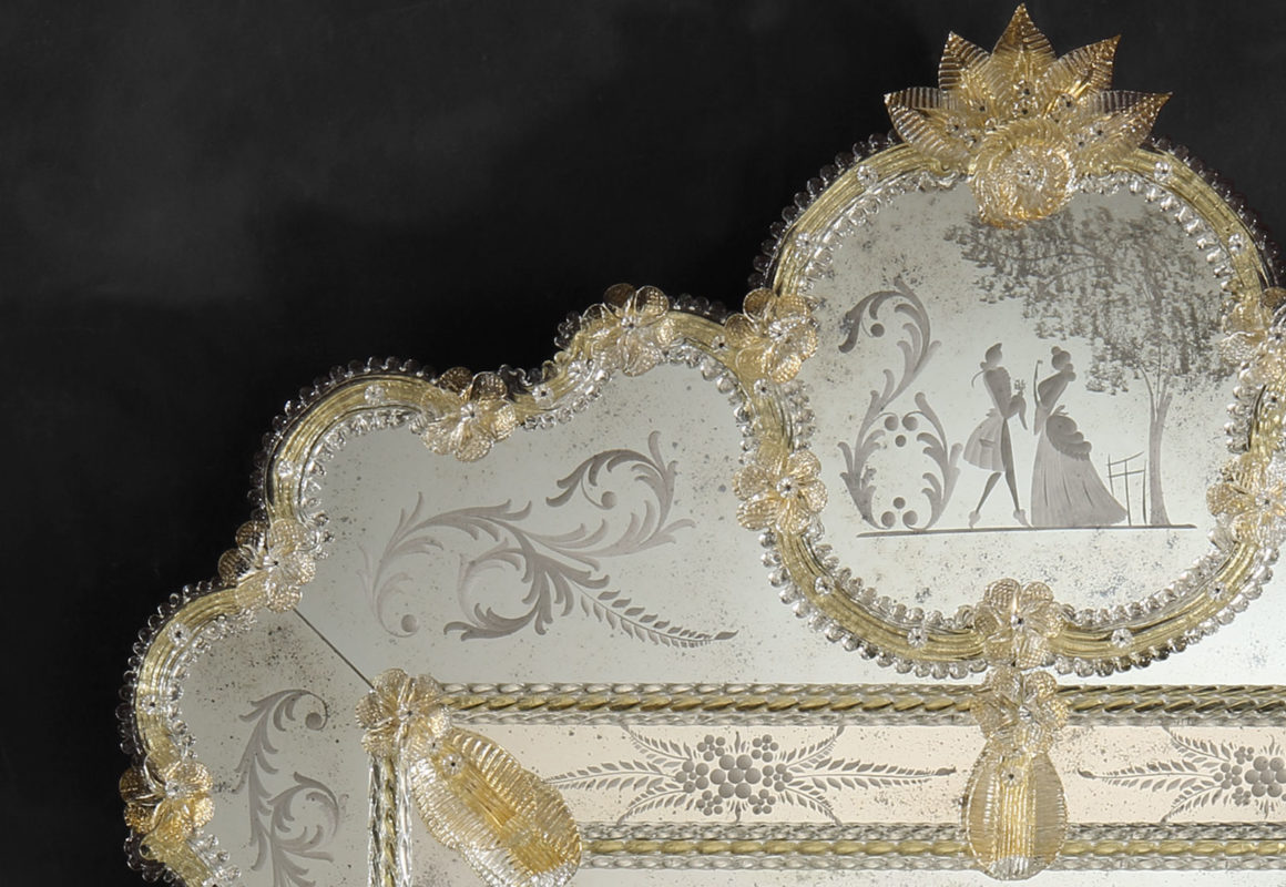Antiqued Venetian mirror framed in hand-etched glass with gold highlights, trimmed with glass ribbons, leaves and rosettes; Hand made in Murano, Italy.