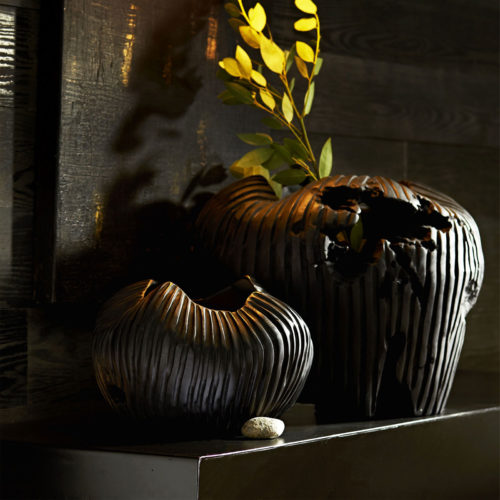 Natural teak root has been unearthed to create this bold and unique centerpiece. The irregular shape and hand-carved ribbed surface deliver a textural quality to the rich ebony finish