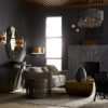 beautiful modern living room with elegant accents. Features antique brass floor lamp with mixed material chandelier to accent the modern fireplace.
