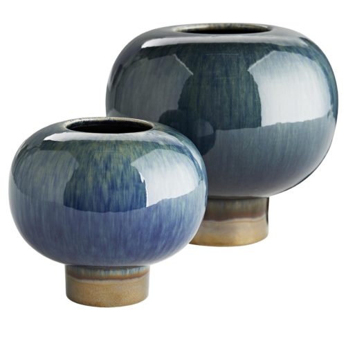 At first glance these vases may look ordinary, though they are anything but. A peacock and bronze reactive glaze breaks over the porcelain ceramic to create a devastatingly beautiful aesthetic.These short and stout vases rest atop a circular platform and are watertight, making them a desirable way to showcase a few bonny blooms.