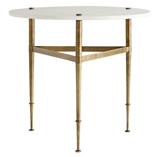 A white marble top adds airiness and classic grandeur to a simple iron base finished in antique brass. Slender legs that pierce through the top andtaper down to decorative feet are united by an iron band, delivering a geometric touch.
