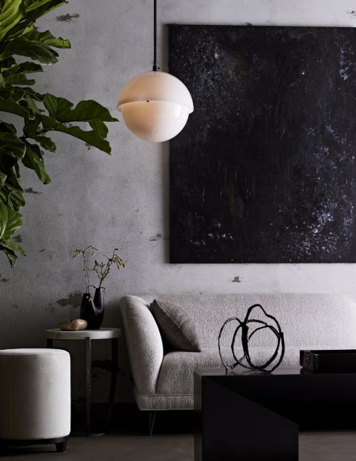 Grays and blacks make for this modern-industrial inspired living room. Add the boucle chaise lounge to soften up your room, adding comfort with bold accents.