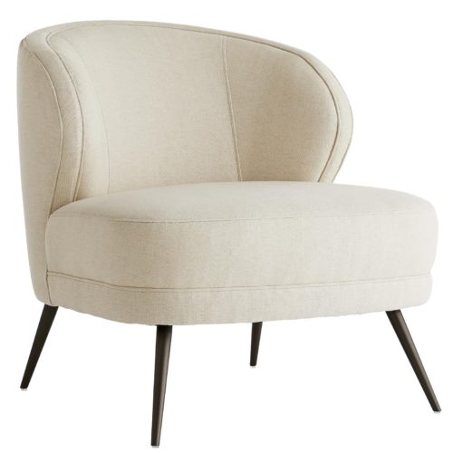 The curved back gives you ample support, while the sloping arms keep you curled up inside. Upholstered in a plush, marigold velvet with welting details to accentuate the curves. The base rests on tapered, light bronze finished metal legs that have a hint of glisten.