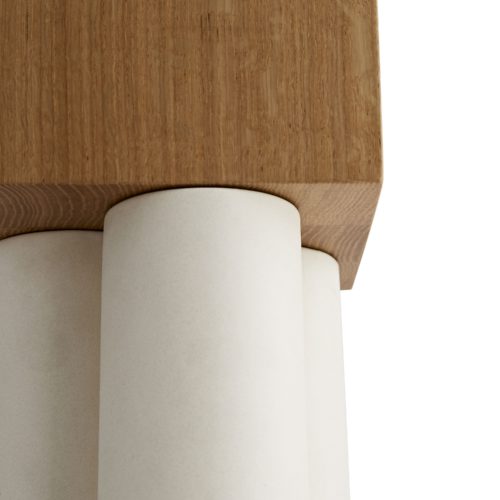 The three ceramic forms play with mixed materials, juxtaposing matte ceramic against oak plinths.