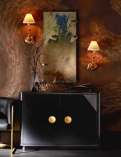 Luxe interior with high gloss black chest and gold accents. Fungi sconces add character to this modern interior.