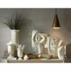 Collection of elegant and modern white decorative accents. French inspired urns with abstract sculptures.